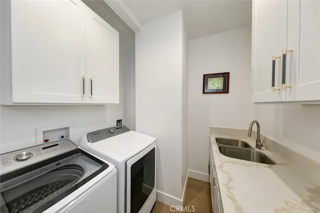 a view of a swimming pool with lawn chairs under an umbrella