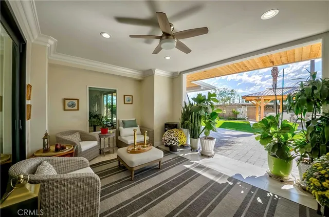 a front view of a house with swimming pool table and chairs