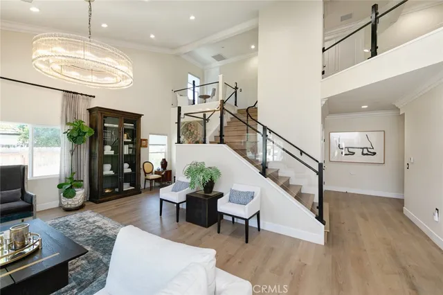 a living room with furniture wooden floor and a large window