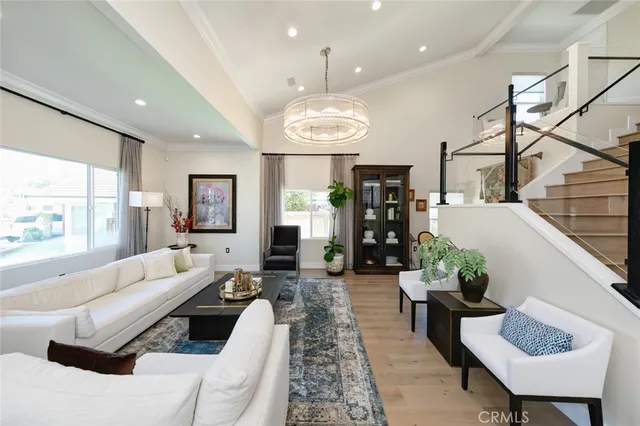 a large white kitchen with a large window and stainless steel appliances
