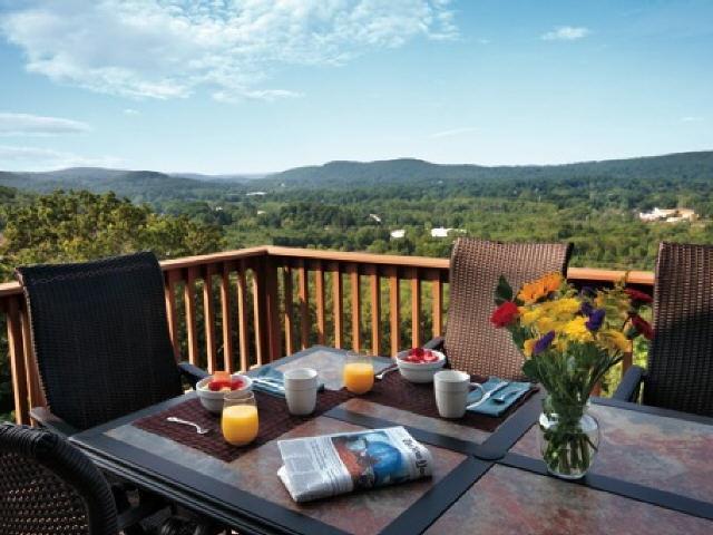 a view of a roof deck with furniture