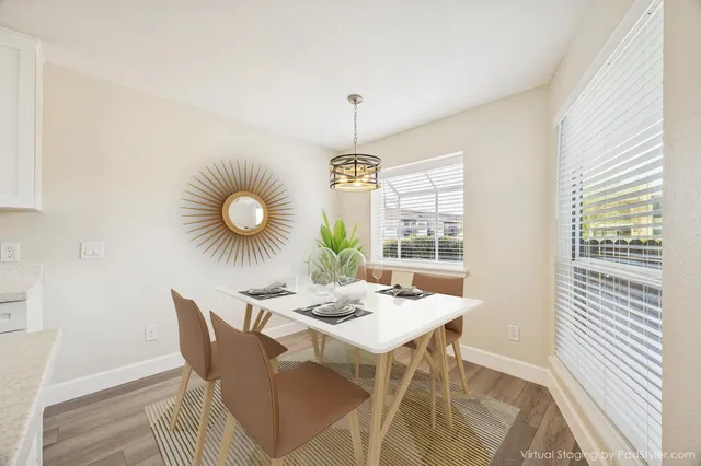 a dining room with furniture and window