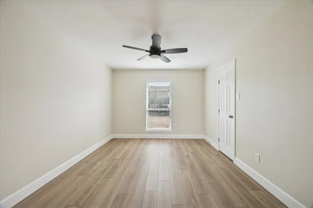 wooden floor in an empty room with a window