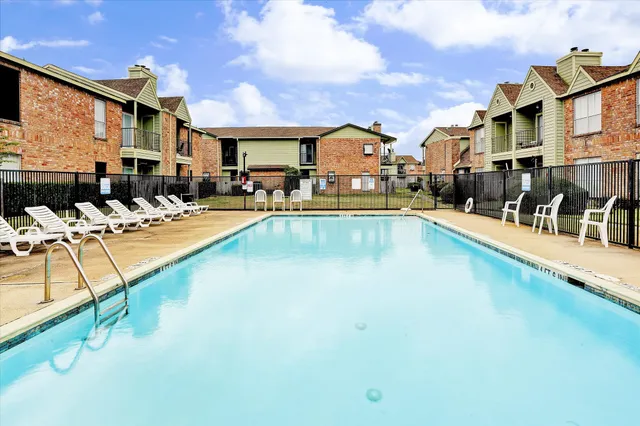 a swimming pool with outdoor seating and yard