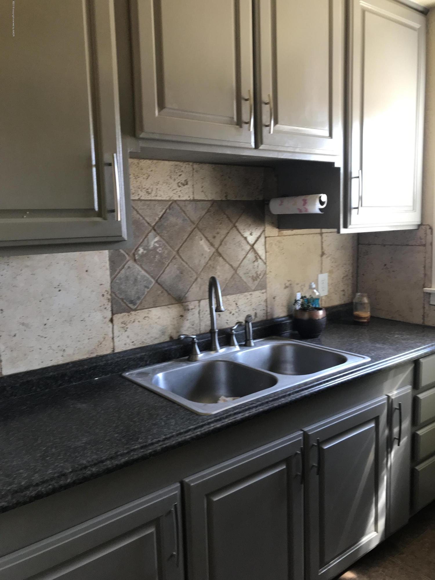 4632 Cline Road Amarillo, TX 79110 - Photo 4 of 27 a kitchen with a sink and cabinets