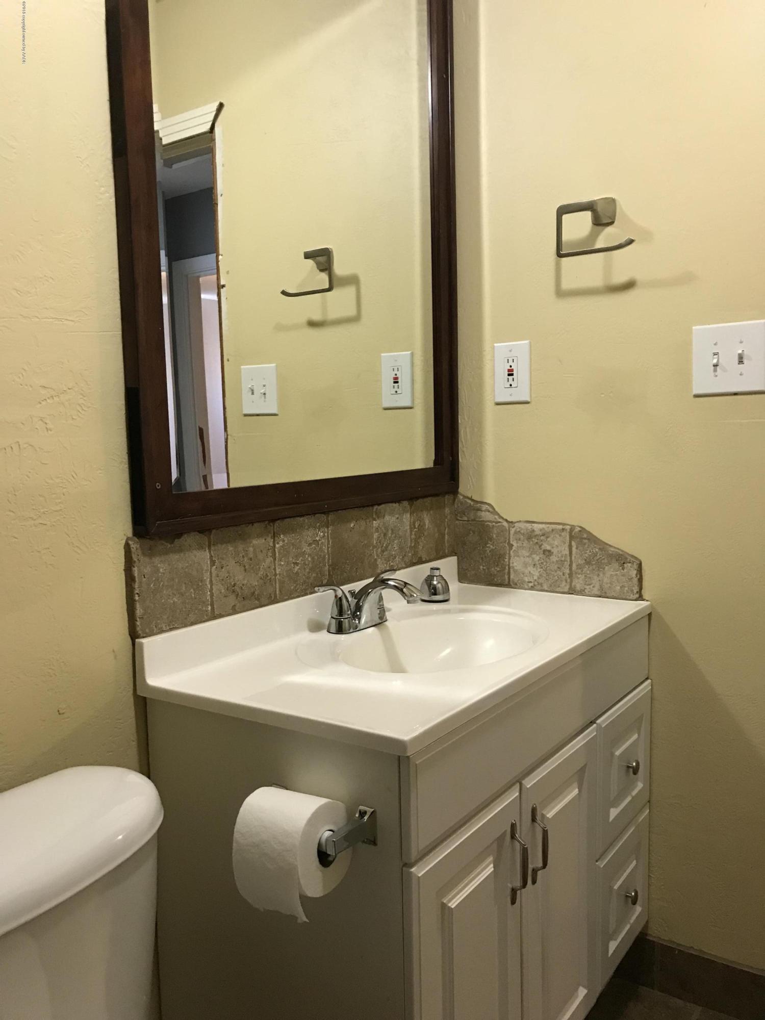 4632 Cline Road Amarillo, TX 79110 - Photo 8 of 27 a bathroom with a sink and a mirror