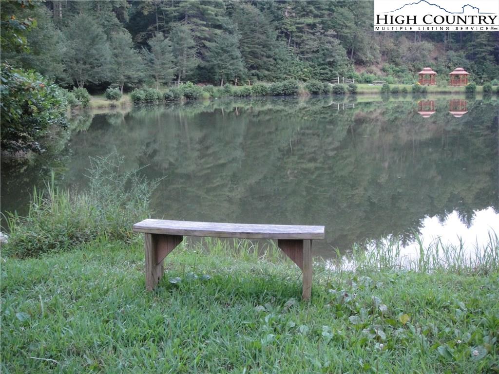 Lot 83 Buck Mountain Road Purlear, NC 28665 - Photo 14 of 30 a view of a wooden fence next to a lake