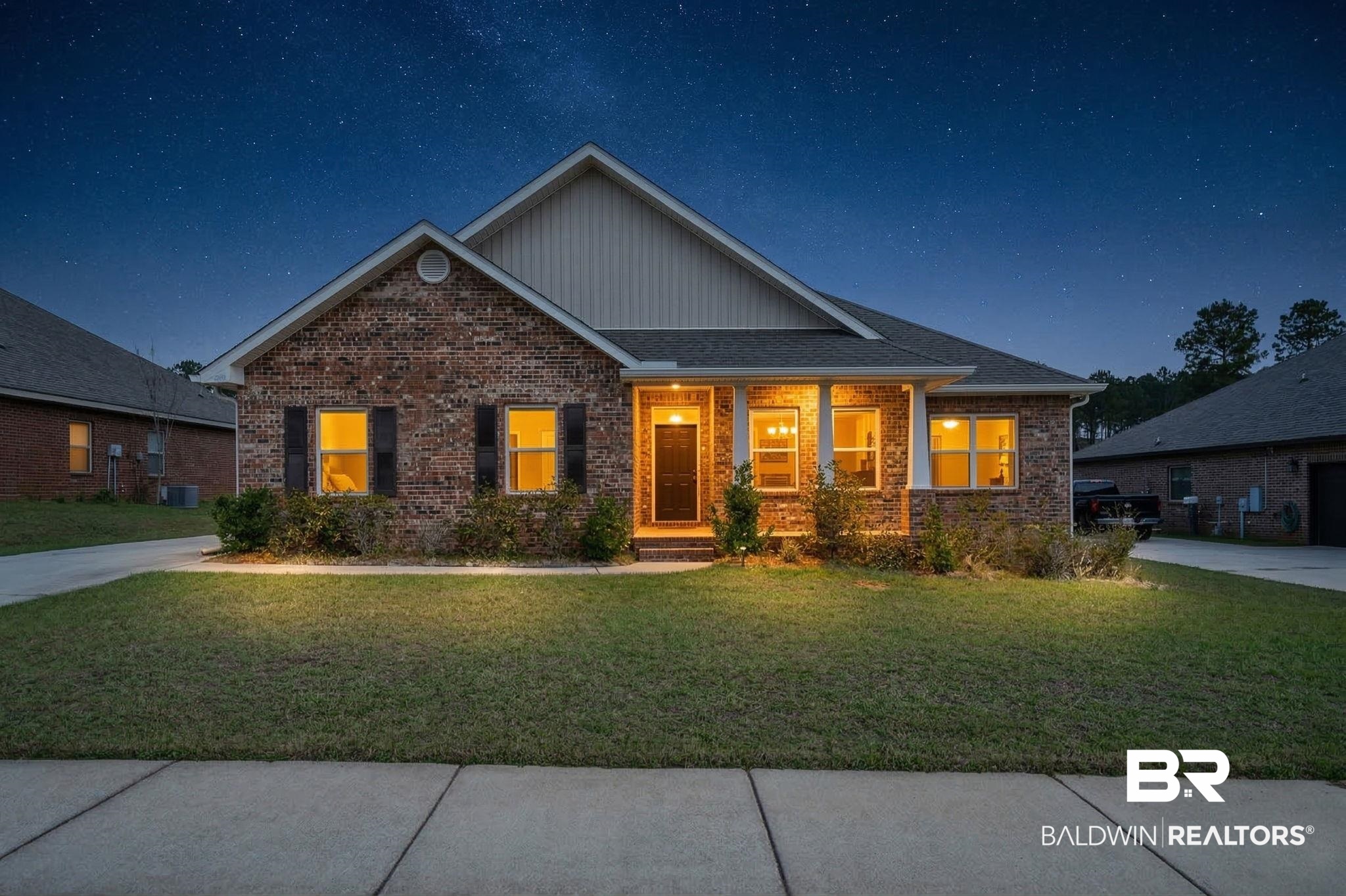 12693 Waxwing Avenue Daphne, AL 36527 - Photo 3 of 43 View of front facade with board and batten siding, a yard, covered porch, and brick siding
