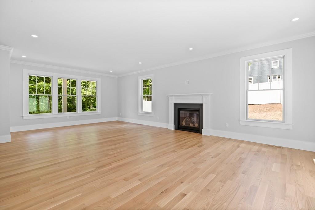 36 Bulow Road Hingham, MA 02043 - Photo 14 of 40 an empty room with large windows and a fireplace