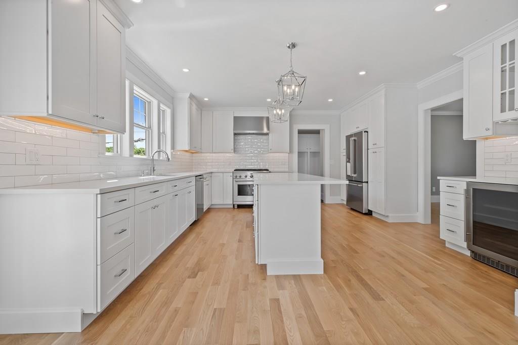 36 Bulow Road Hingham, MA 02043 - Photo 5 of 40 a large kitchen with stainless steel appliances kitchen island a large counter top and a stove top oven
