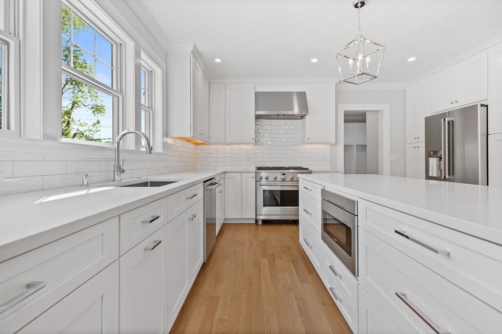 36 Bulow Road Hingham, MA 02043 - Photo 6 of 40 a kitchen with granite countertop a sink dishwasher a stove and a refrigerator