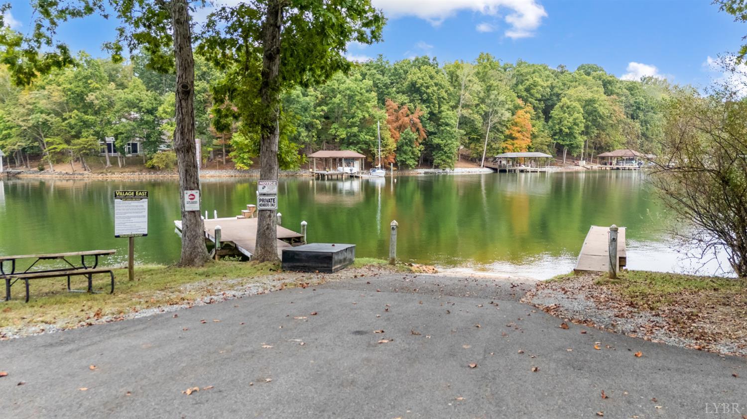 101 Little Creek Road Moneta, VA 24121 - Photo 18 of 76 a view of a lake with a bench next to a lake