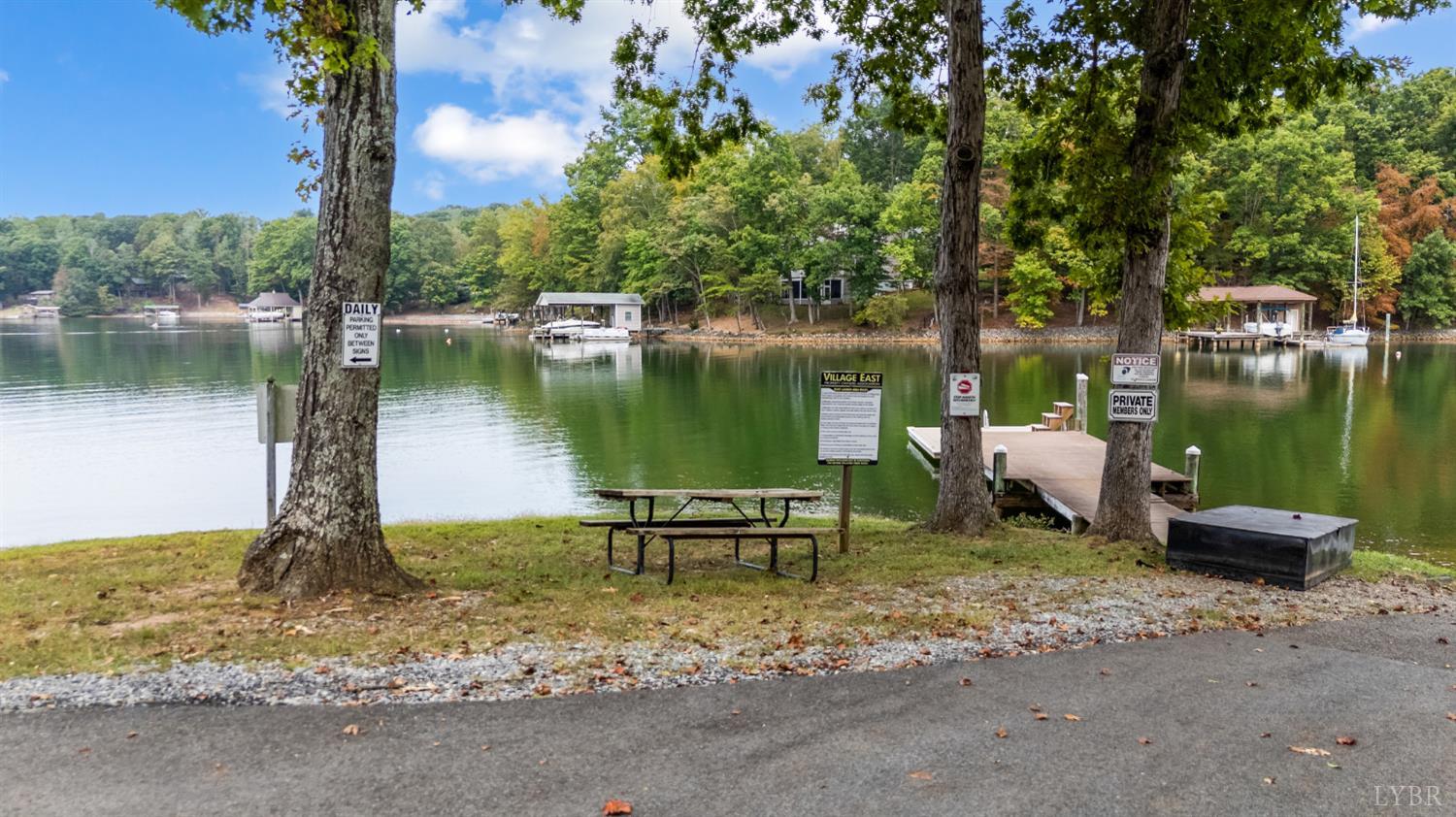101 Little Creek Road Moneta, VA 24121 - Photo 19 of 76 a lake view with a bench under a large tree