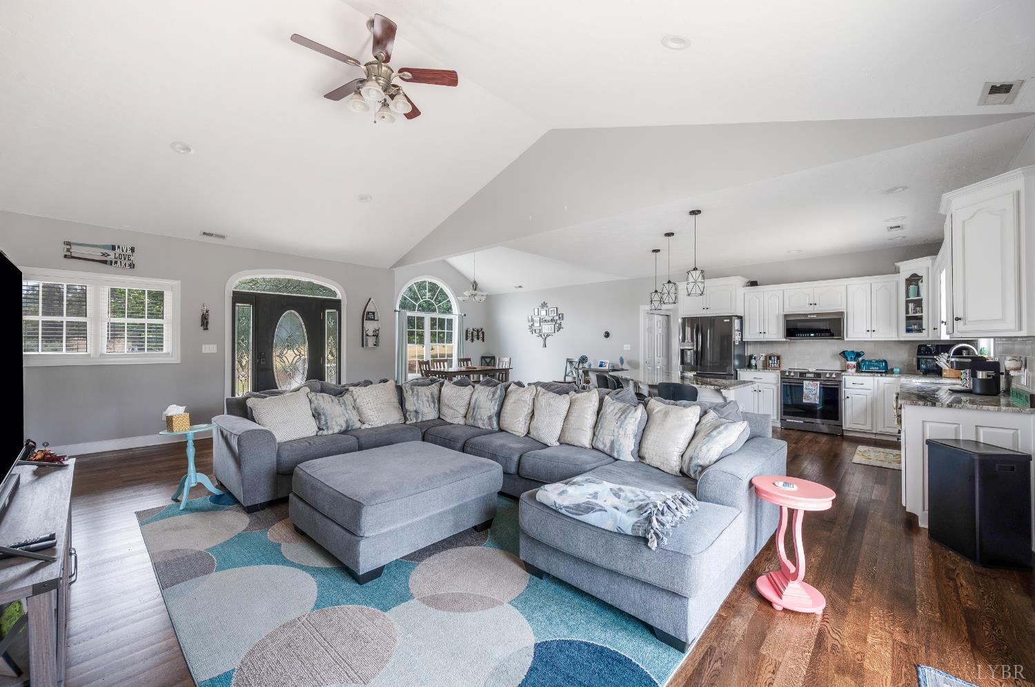 101 Little Creek Road Moneta, VA 24121 - Photo 26 of 76 a living room with furniture kitchen view and a chandelier
