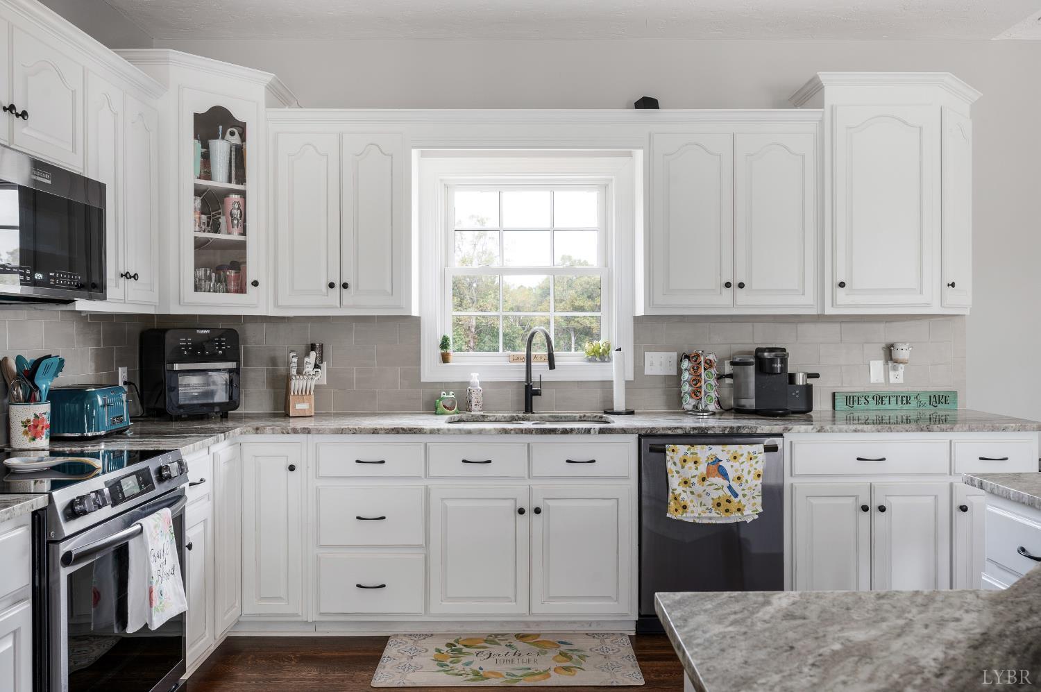 101 Little Creek Road Moneta, VA 24121 - Photo 29 of 76 a kitchen with stainless steel appliances granite countertop a stove a sink and a white cabinets