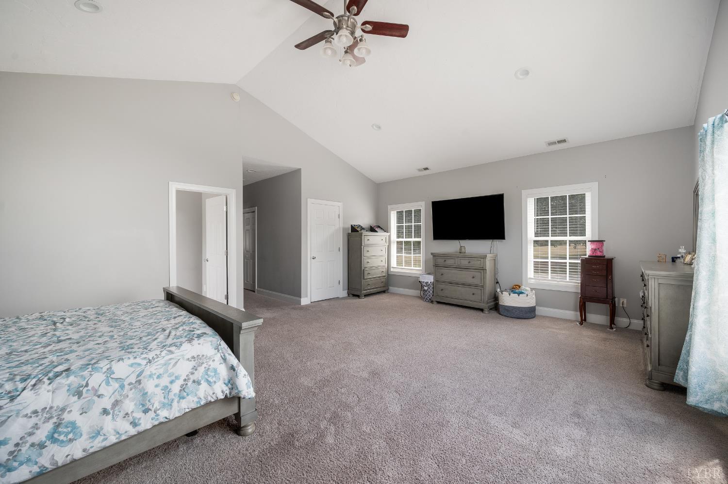 101 Little Creek Road Moneta, VA 24121 - Photo 47 of 76 a spacious bedroom with a bed and a flat screen tv