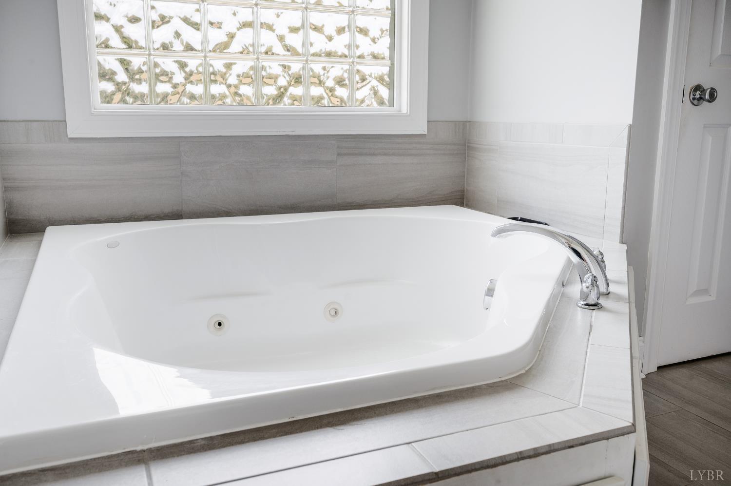 101 Little Creek Road Moneta, VA 24121 - Photo 53 of 76 a bathroom with a bathtub and a window