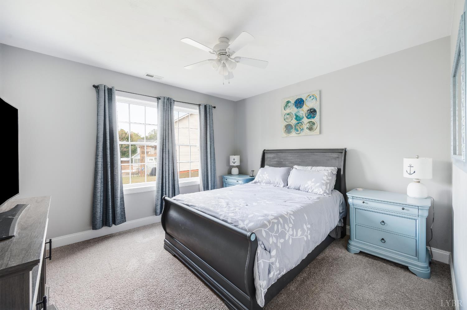 101 Little Creek Road Moneta, VA 24121 - Photo 58 of 76 a bedroom with a bed and a chandelier