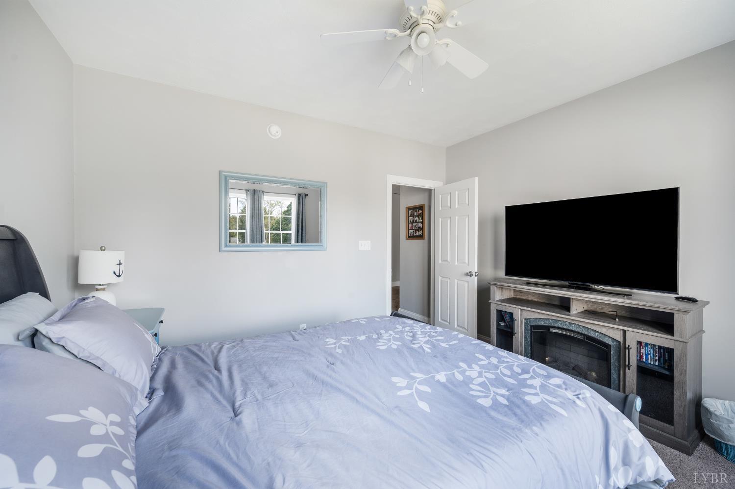 101 Little Creek Road Moneta, VA 24121 - Photo 59 of 76 a bedroom with a bed and a flat screen tv