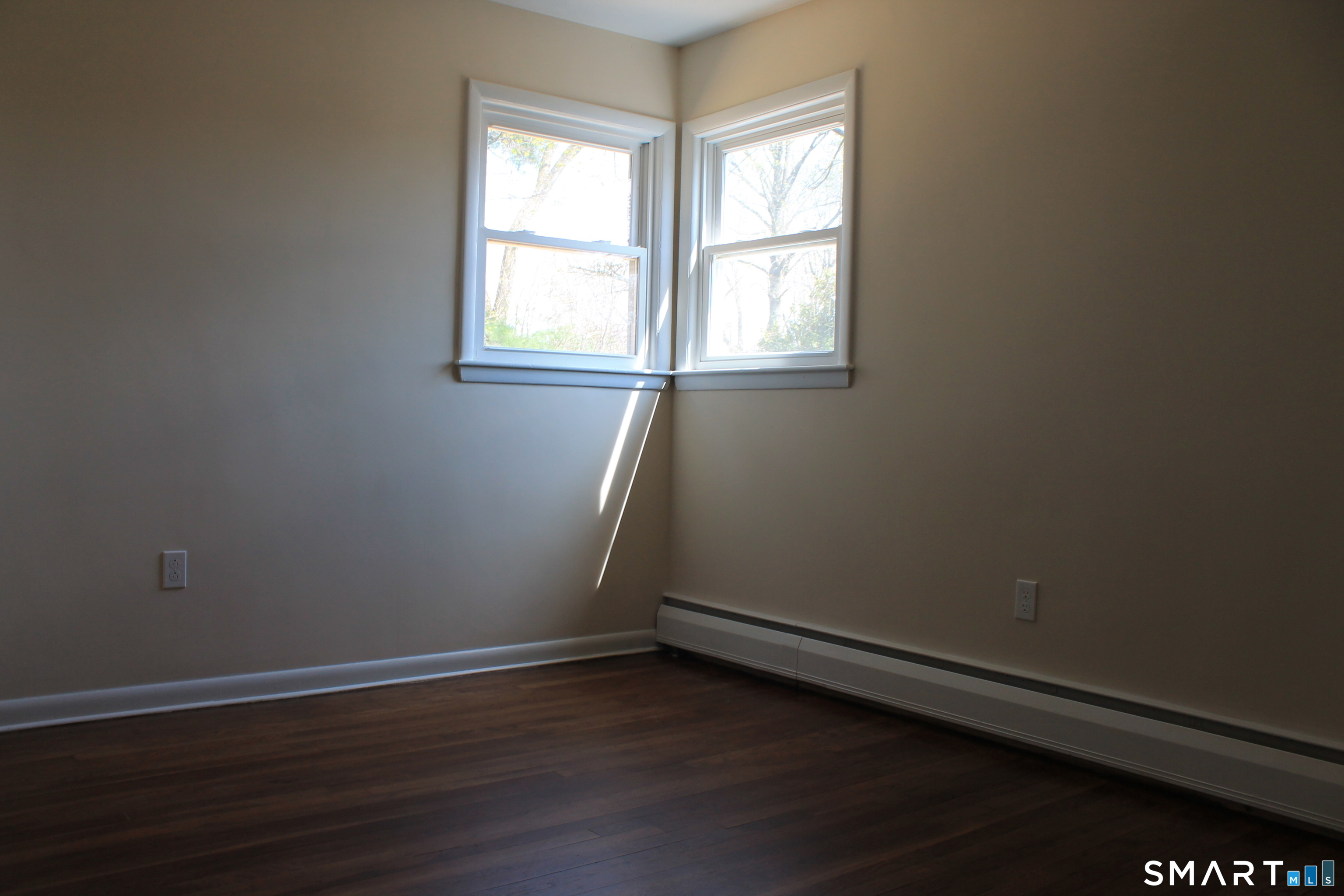 134 Sunset Street Windsor Locks, CT 06096 - Photo 21 of 23 an empty room with wooden floor and windows