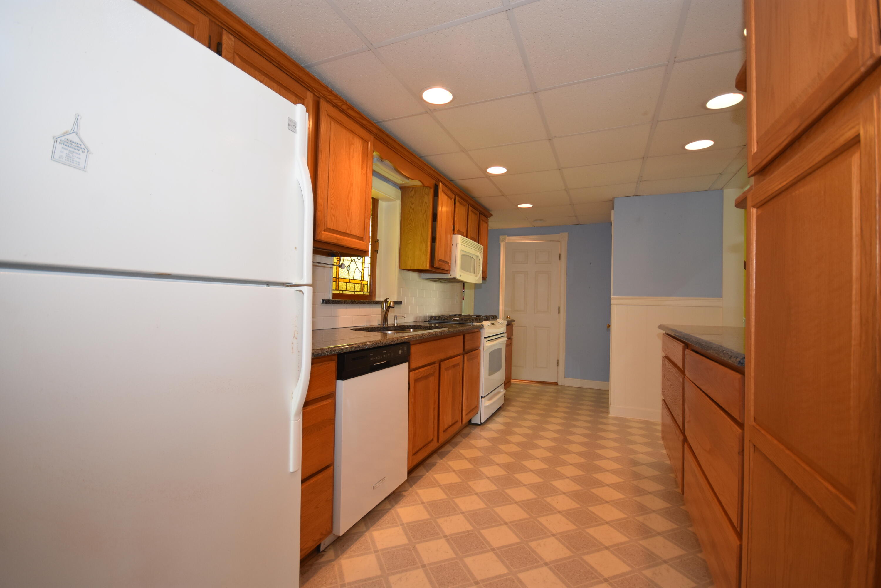 355 Williston Road Sagamore Beach, MA 02562 - Photo 8 of 31 a kitchen with stainless steel appliances granite countertop a refrigerator a sink dishwasher a oven with white cabinets
