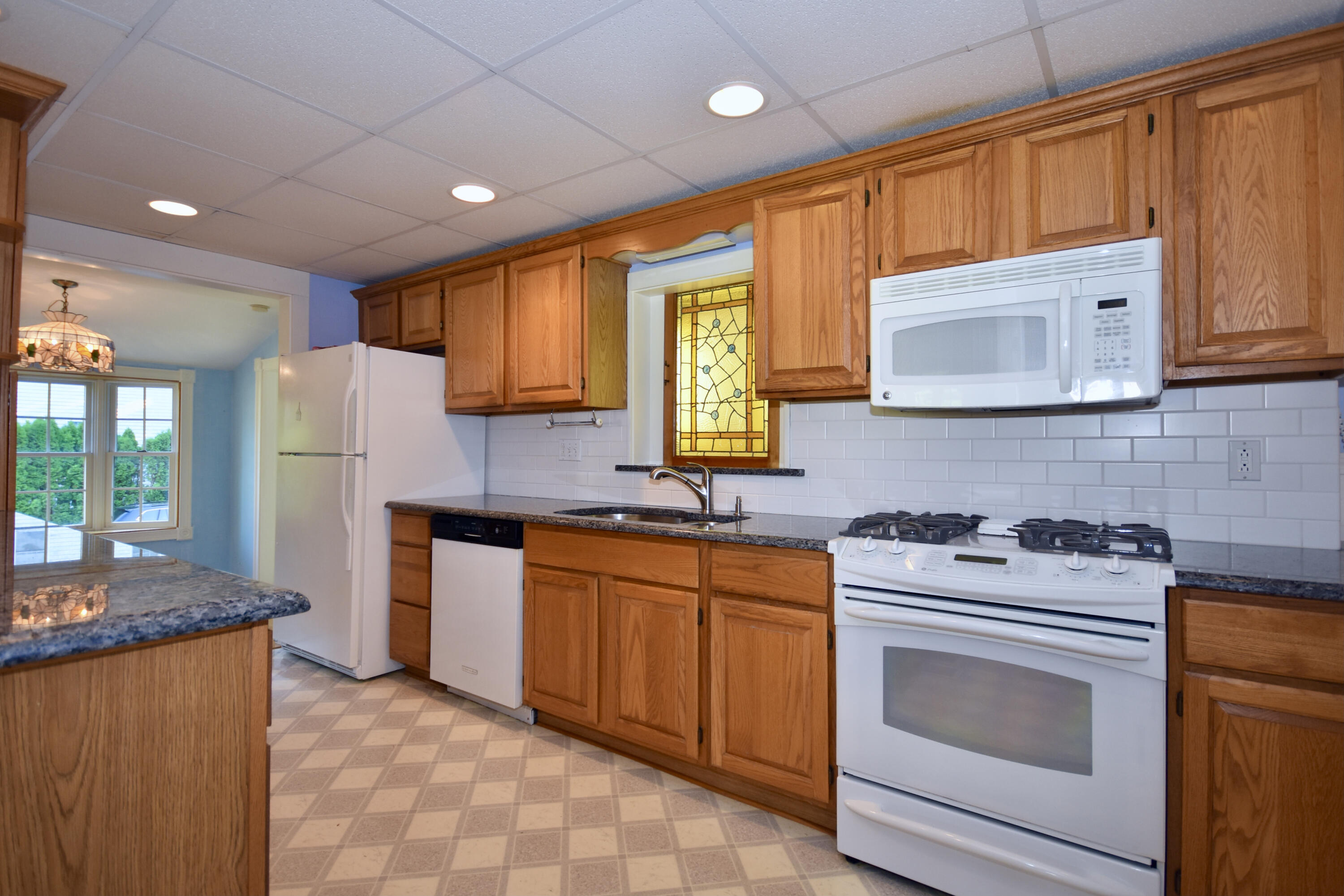 355 Williston Road Sagamore Beach, MA 02562 - Photo 9 of 31 a kitchen with stainless steel appliances granite countertop wooden cabinets stove top oven and sink