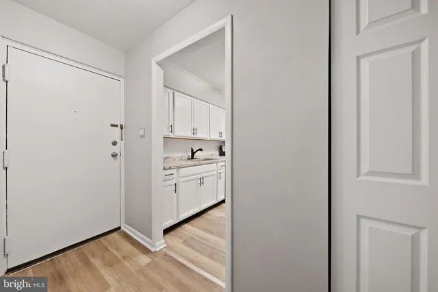 a kitchen with white cabinets and white appliances