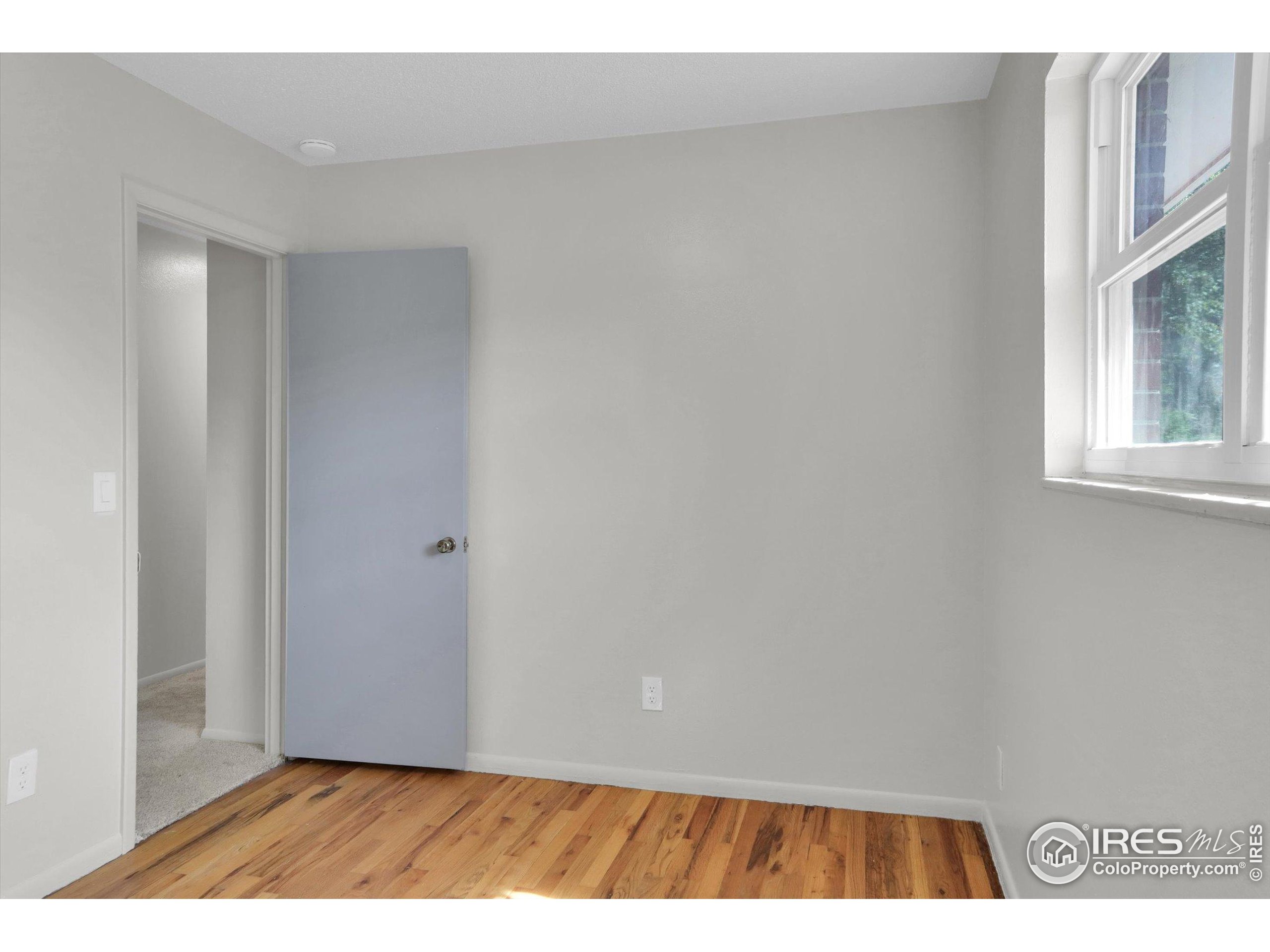4630 Macky Way Boulder, CO 80305 - Photo 17 of 40 a view of an empty room with wooden floor and a window