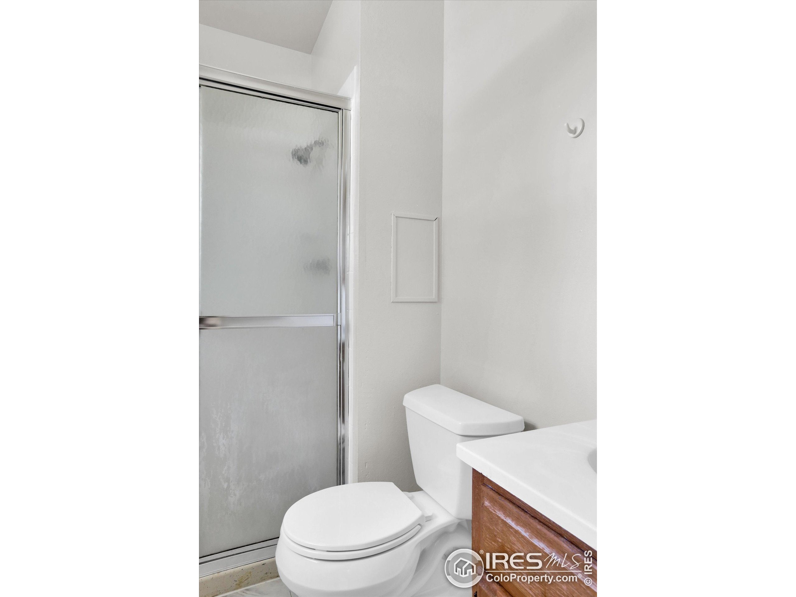 4630 Macky Way Boulder, CO 80305 - Photo 21 of 40 a white toilet sitting next to a bathroom sink and a shower