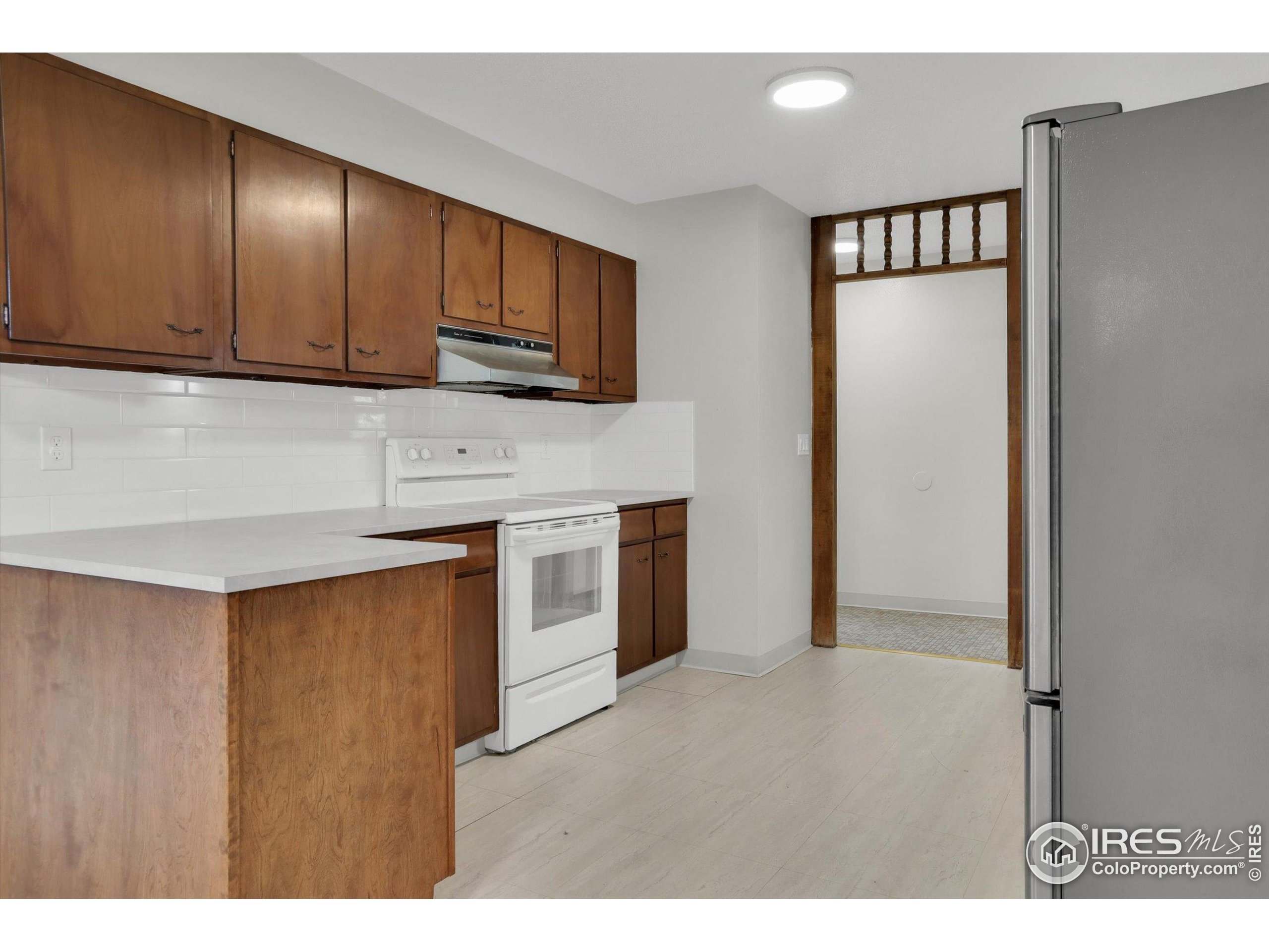 4630 Macky Way Boulder, CO 80305 - Photo 5 of 40 a kitchen with stainless steel appliances granite countertop a refrigerator a sink dishwasher and wooden cabinets