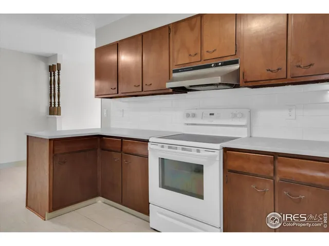 a kitchen with stainless steel appliances granite countertop cabinets and window