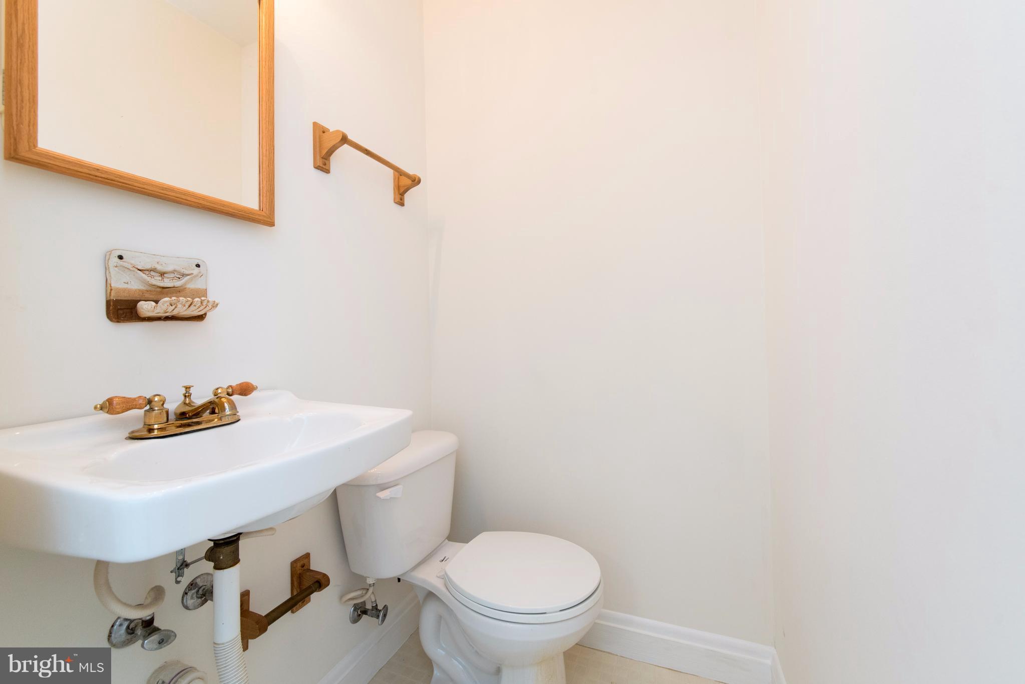 1906 Glen Ridge Road Towson, MD 21286 - Photo 11 of 30 a bathroom with a sink a toilet and a mirror