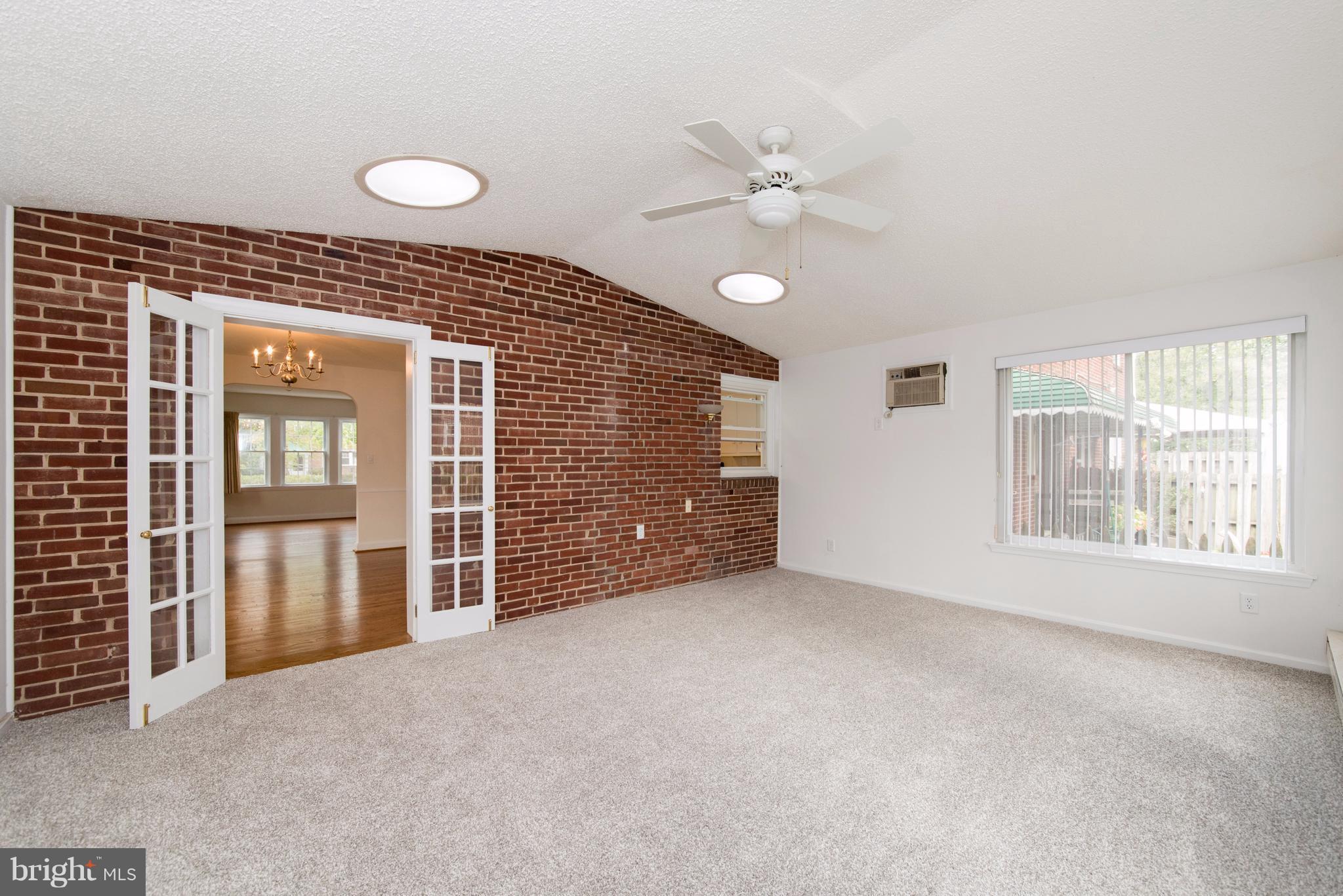 1906 Glen Ridge Road Towson, MD 21286 - Photo 14 of 30 a view of an empty room with window and chandelier fan