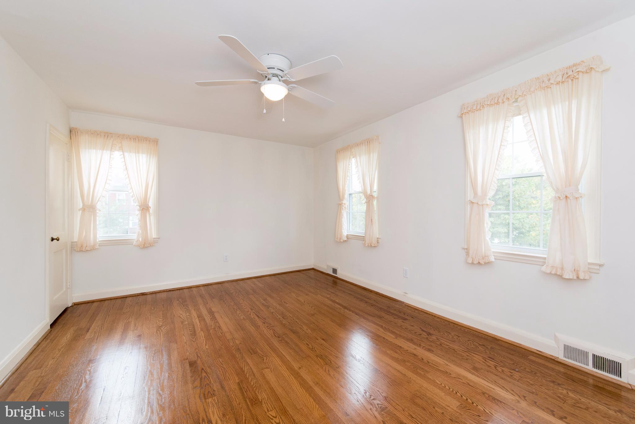 1906 Glen Ridge Road Towson, MD 21286 - Photo 15 of 30 a view of an empty room with wooden floor and window