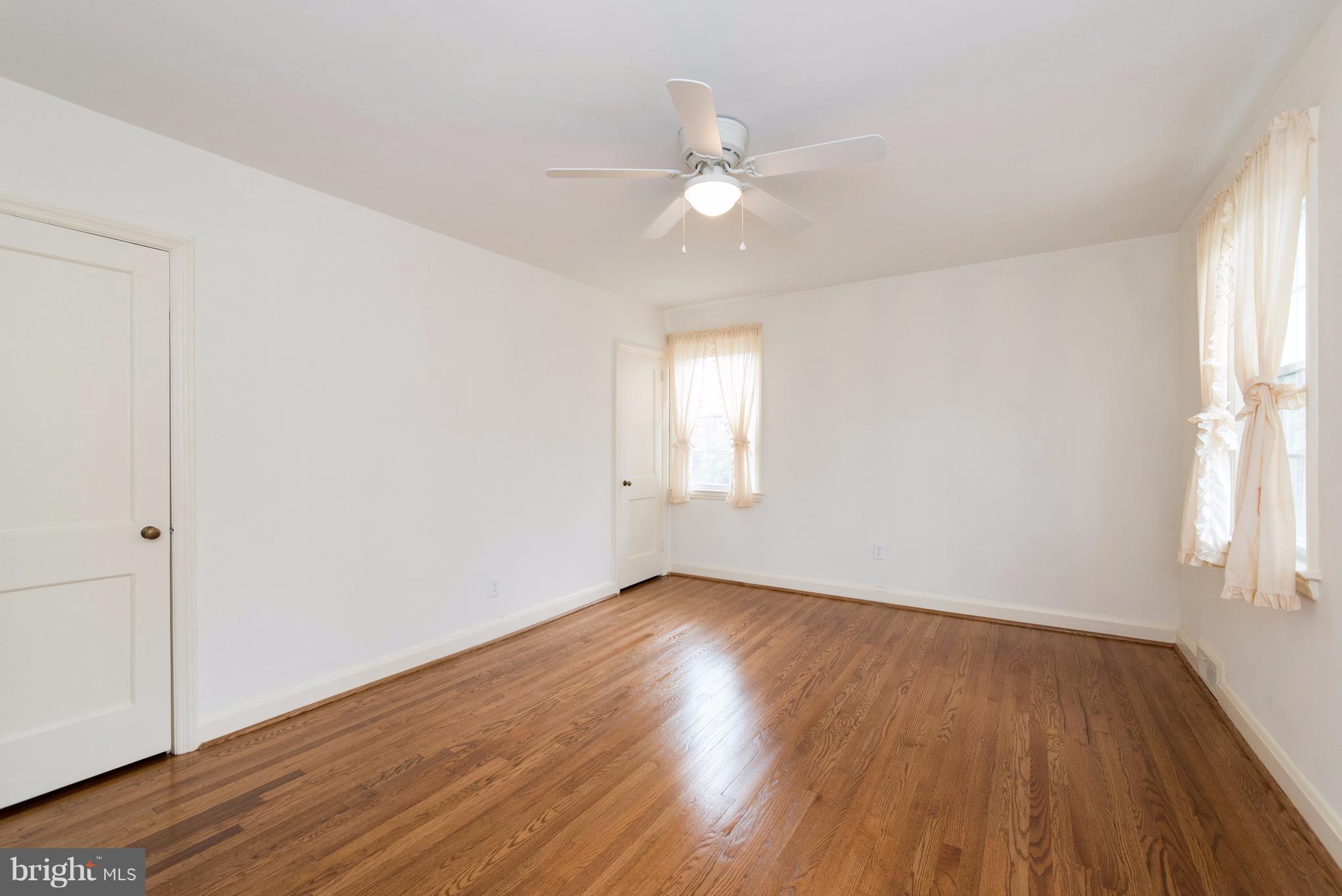 1906 Glen Ridge Road Towson, MD 21286 - Photo 16 of 30 an empty room with wooden floor and windows