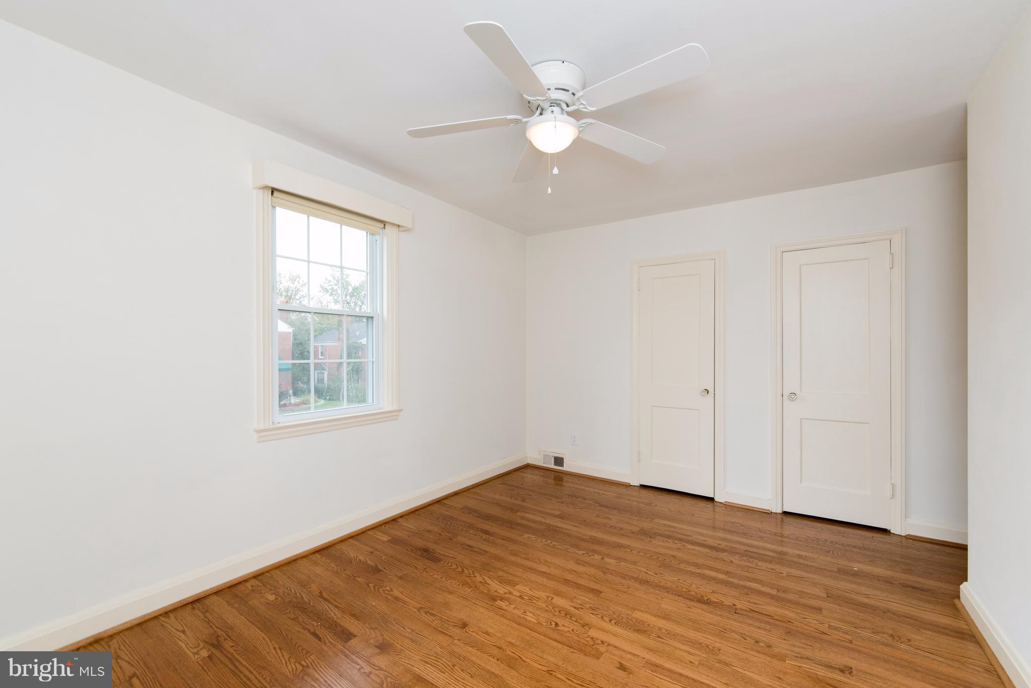 1906 Glen Ridge Road Towson, MD 21286 - Photo 17 of 30 an empty room with wooden floor and windows
