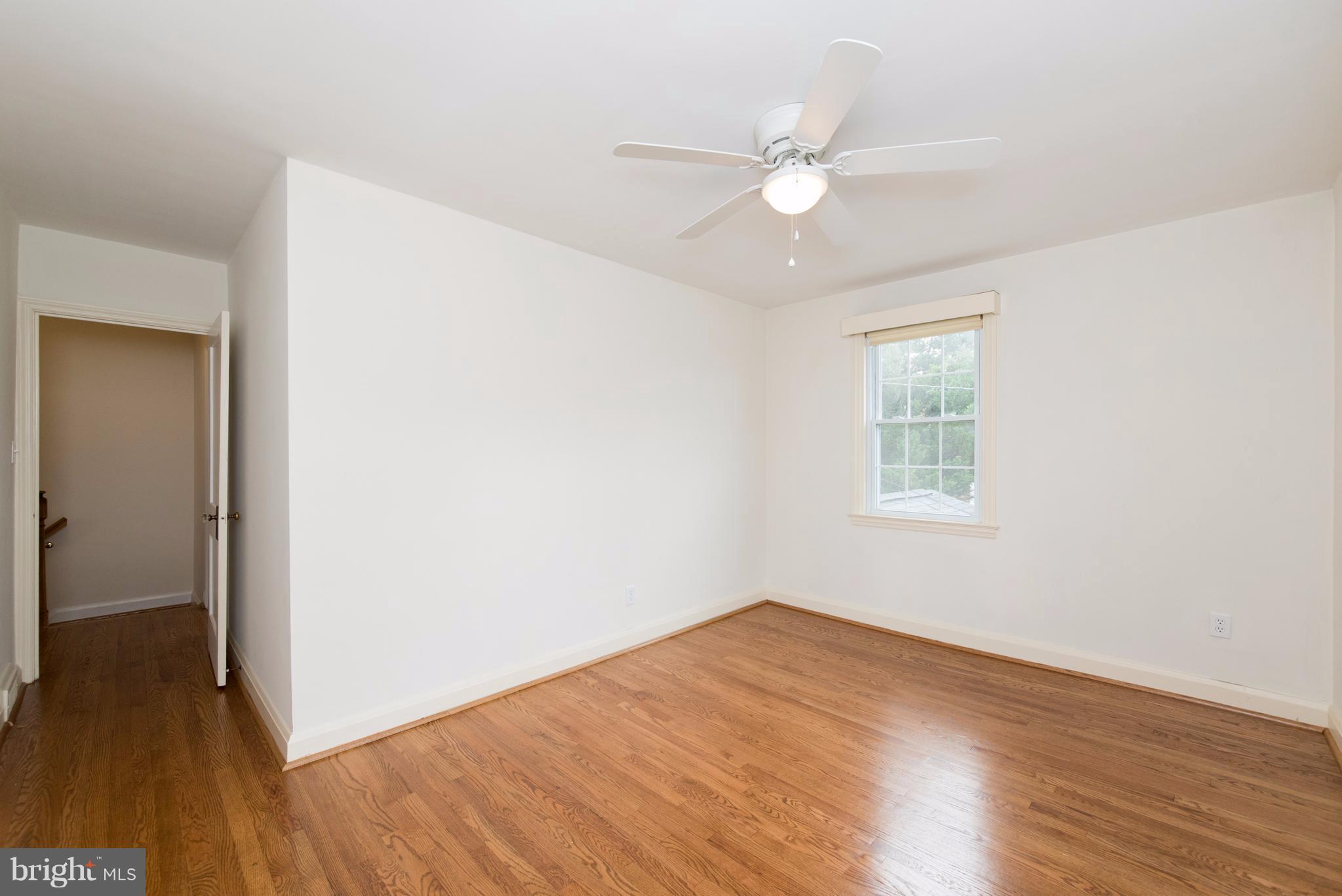 1906 Glen Ridge Road Towson, MD 21286 - Photo 18 of 30 an empty room with wooden floor fan and windows