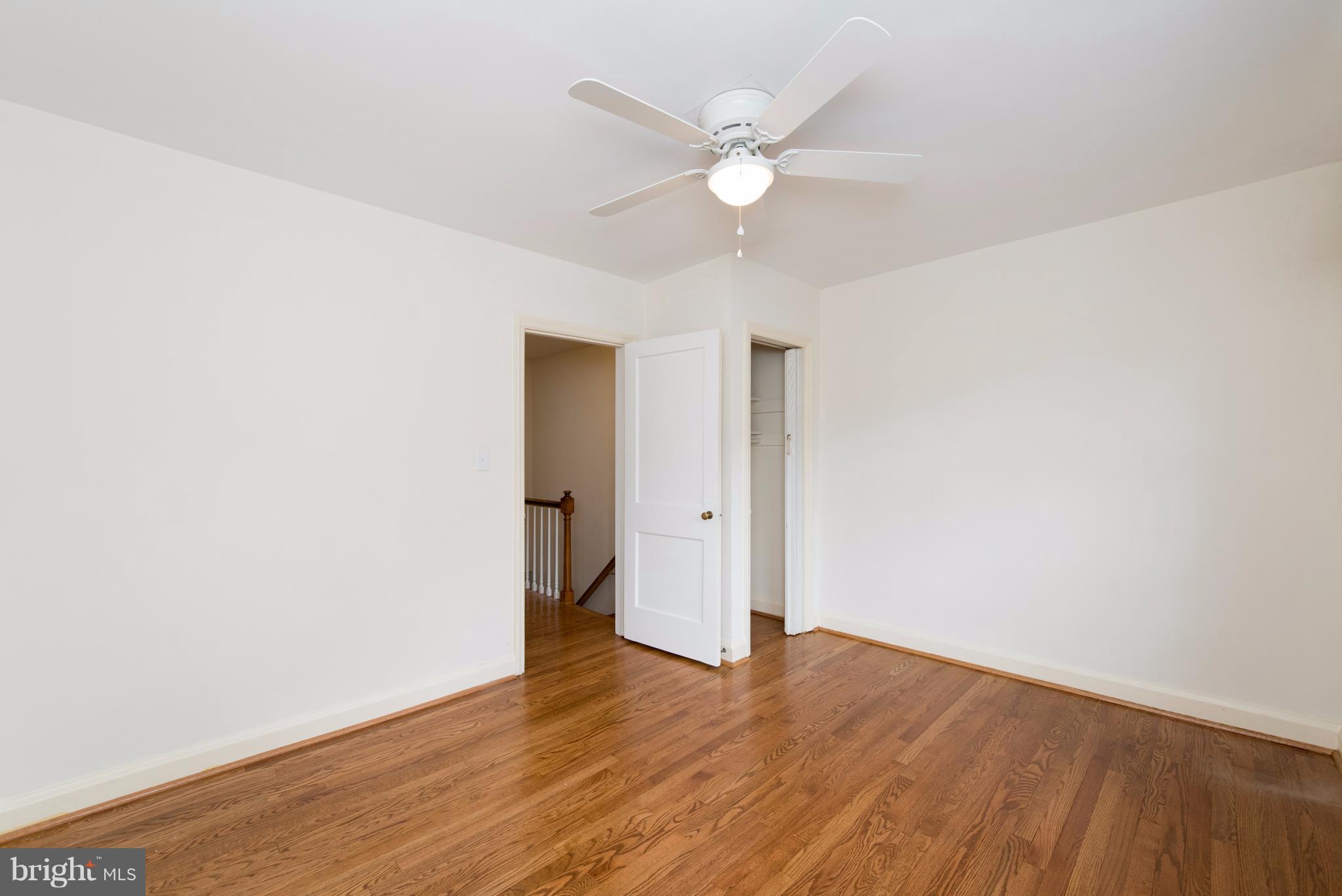 1906 Glen Ridge Road Towson, MD 21286 - Photo 19 of 30 an empty room with wooden floor and fan