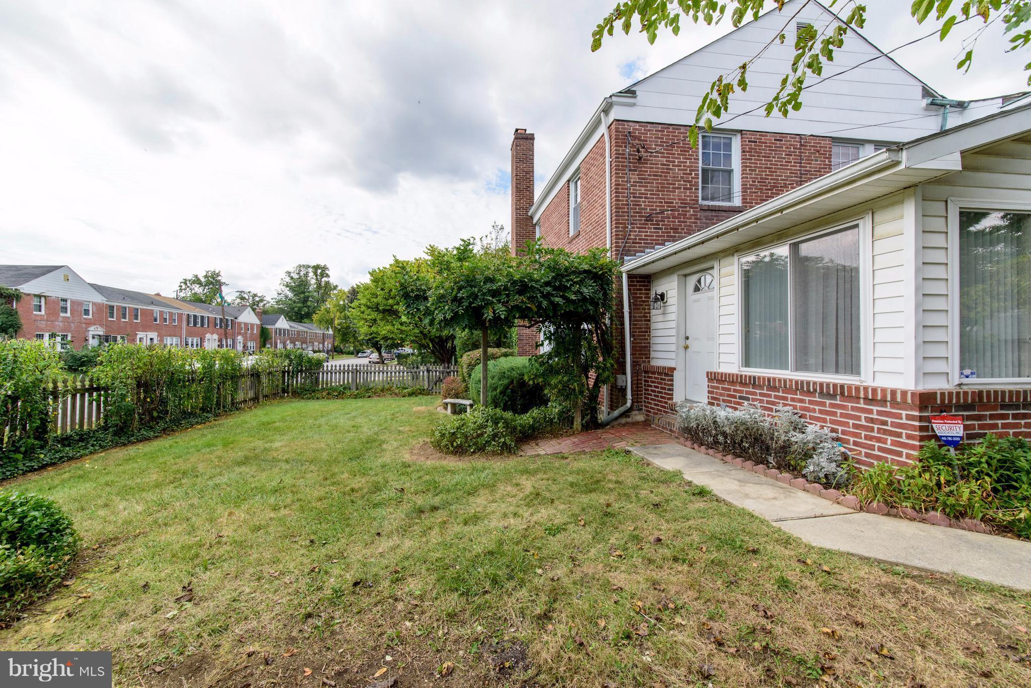 1906 Glen Ridge Road Towson, MD 21286 - Photo 27 of 30 a view of a house with brick walls and a yard with plants