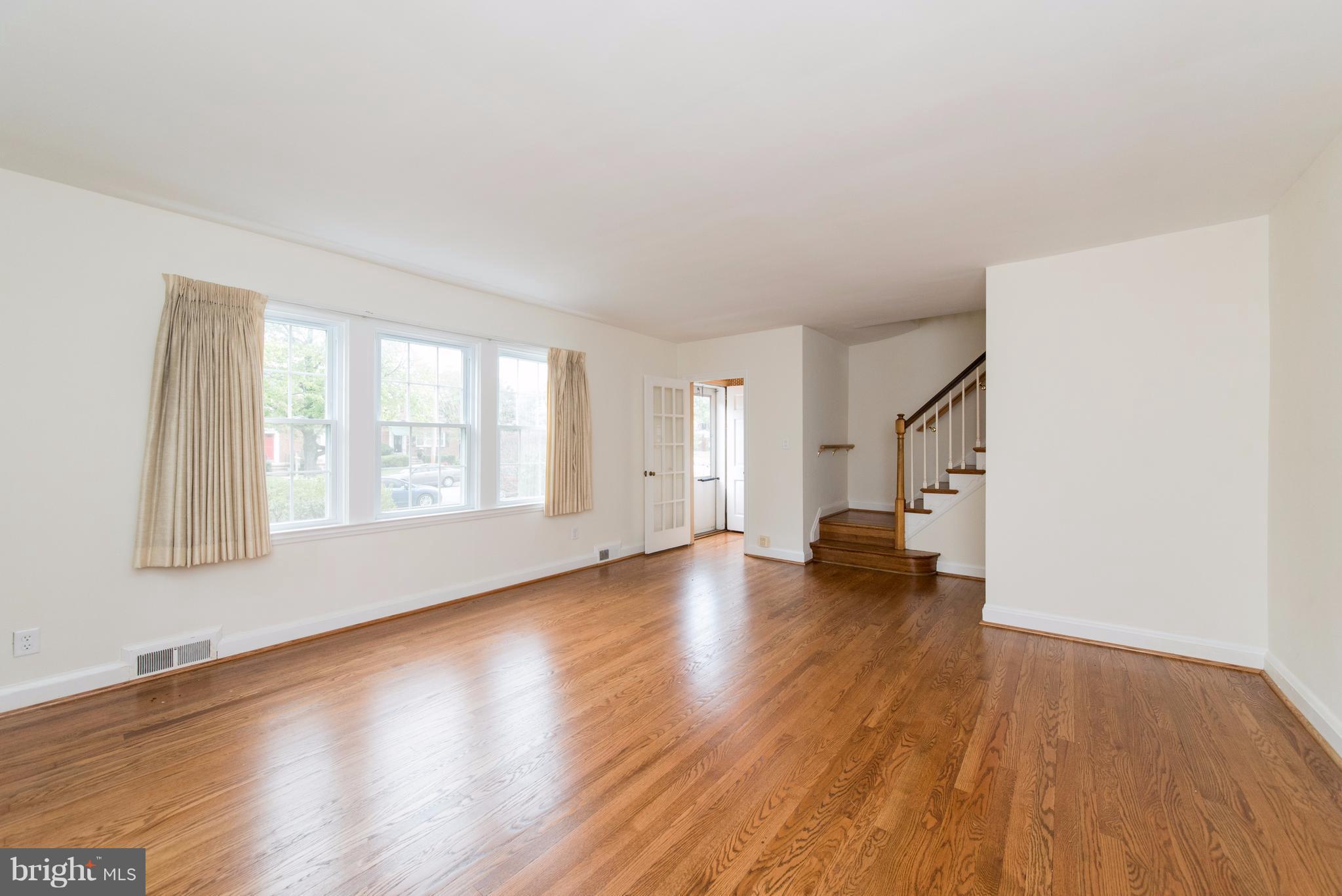 1906 Glen Ridge Road Towson, MD 21286 - Photo 4 of 30 an empty room with wooden floor and windows
