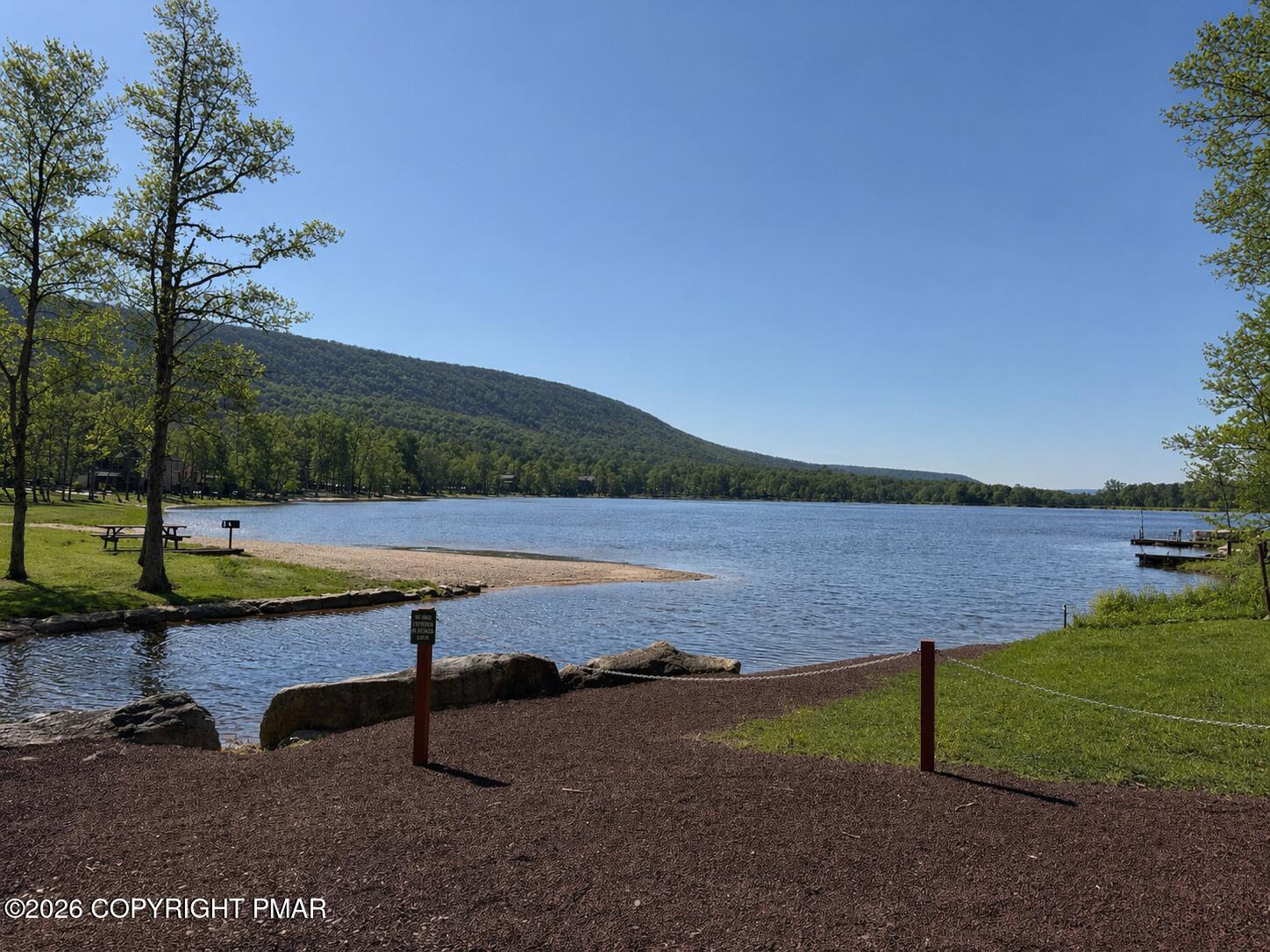 Buttonbush Lane Hazleton, PA 18202 - Photo 2 of 6 a view of a lake with a yard and large trees