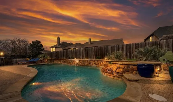 a swimming pool with outdoor seating and yard