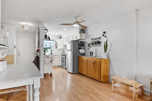 a kitchen with cabinets and wooden floors