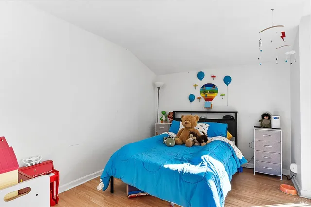 a bed sitting in a bedroom next to a window