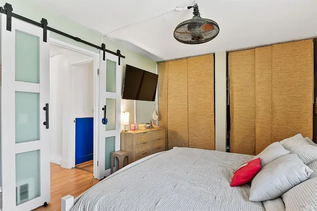 a bedroom with a bed and a flat screen tv