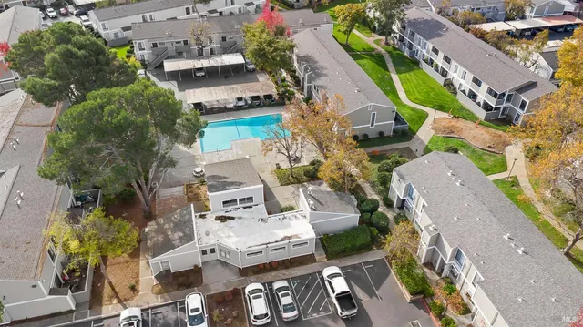 an aerial view of multiple houses with yard