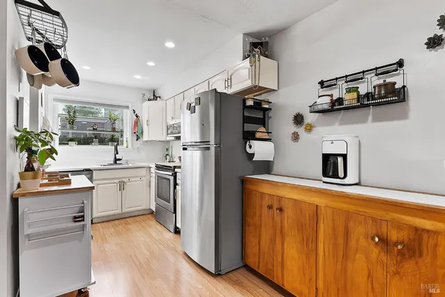 a kitchen with cabinets and steel stainless steel appliances