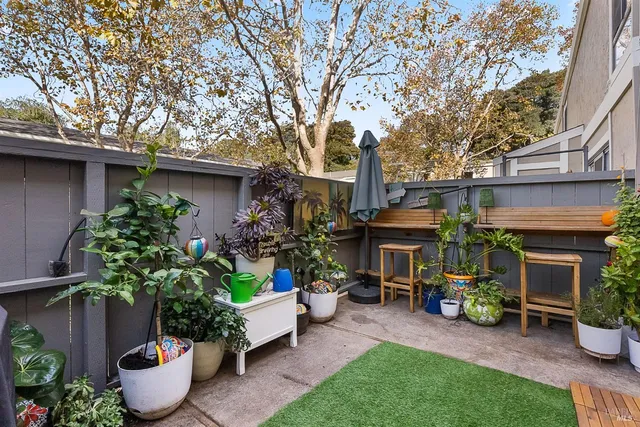 a front view of a house with sitting area and potted plants
