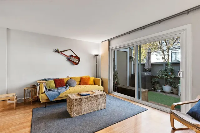 a living room with furniture and a floor to ceiling window