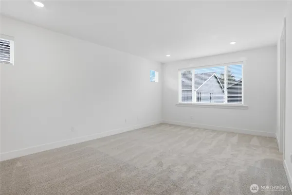 a bathroom with a toilet a sink a mirror and a shower